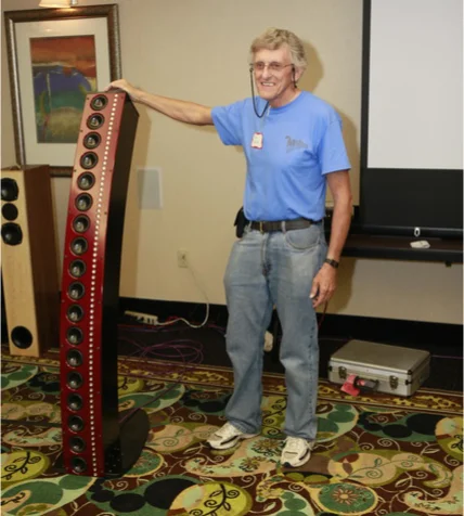 A photo of D. B. (Don) Keele, Jr. standing next to a CBT36 Prototype at a hi-fi show.